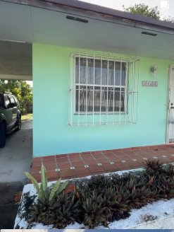 Mint-green South Florida house with security bars — Prop Hunters project